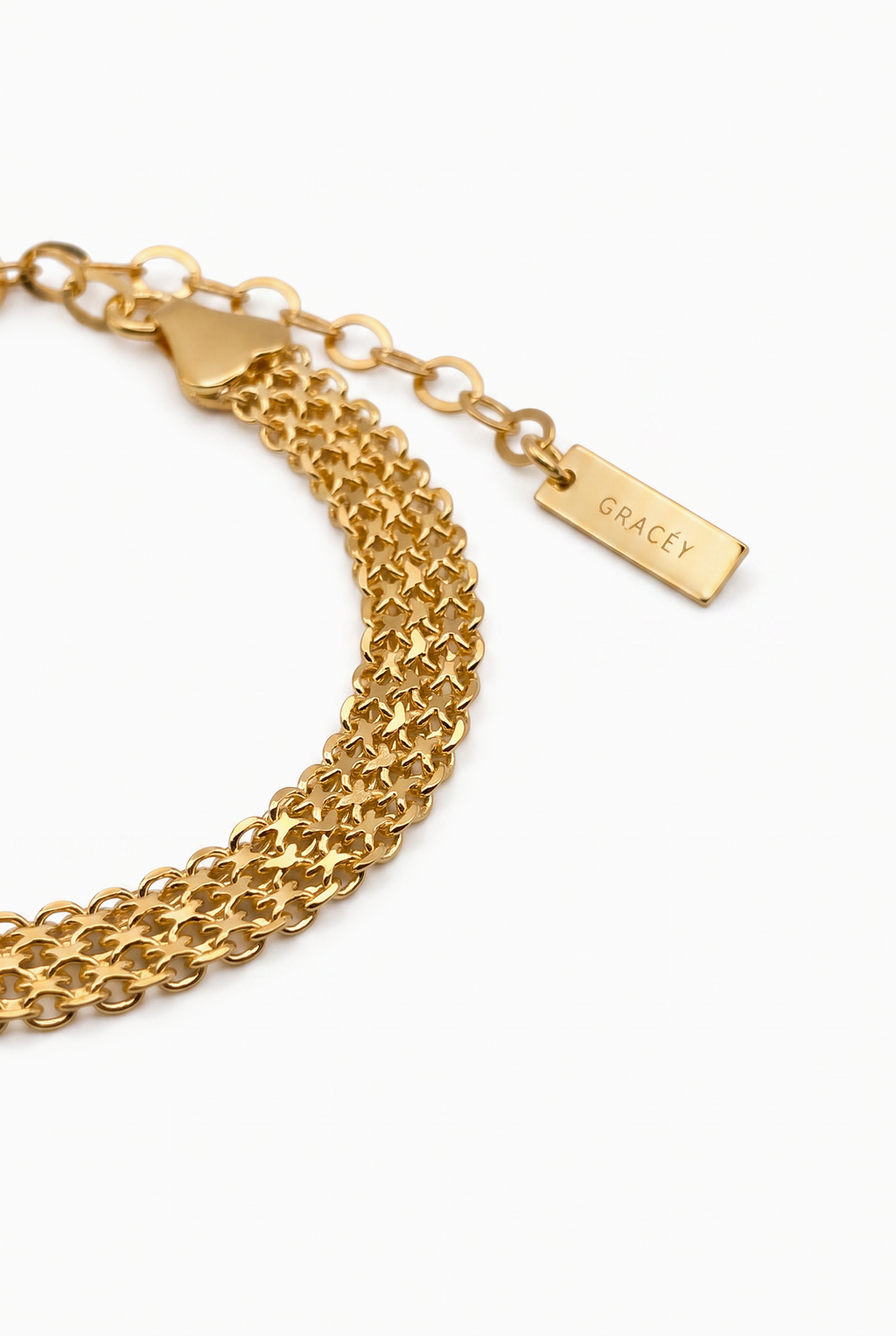 A gold chain bracelet with a multi-strand design, featuring a lobster clasp and an adjustable extender chain with a rectangular tag engraved with the name 'GRACÉY'.